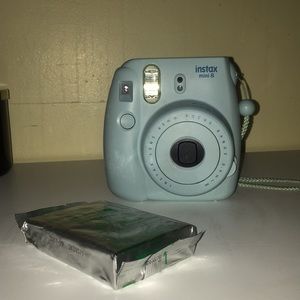 blue / teal fugifilm instax mini 8 polaroid camera